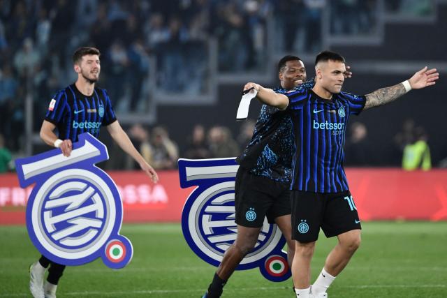 Inter Milan's Croatian midfielder #08 Petar Sucic (LL), Inter Milan's Dutch defender #02 Denzel Dumfries Inter Milan's Argentine forward #10 Lautaro Martinez (R) celebrate after Inter won the Italian Cup (Coppa Italia) final football match between Lazio Rome and Inter Milan at the Olympic stadium in Rome on May 13, 2026. (Photo by Isabella BONOTTO / AFP)