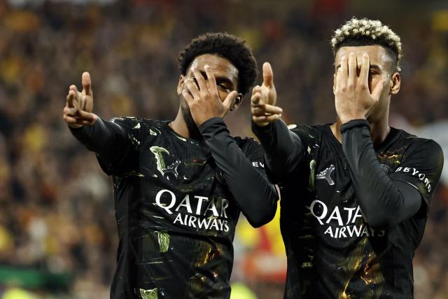 TOPSHOT - Paris Saint-Germain's French forward #49 Ibrahim Mbaye (L) celebrates with Paris Saint-Germain's French midfielder #14 Desire Doue after scoring a goal during the French L1 football match between RC Lens and Paris Saint-Germain (PSG) at the Stade Bollaert-Delelis stadium in Lens on May 13, 2026. (Photo by SIMON WOHLFAHRT / AFP)