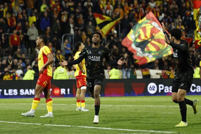 Paris Saint-Germain's French forward #49 Ibrahim Mbaye (C) celebrates after scoring a goal during the French L1 football match between RC Lens and Paris Saint-Germain (PSG) at the Stade Bollaert-Delelis stadium in Lens on May 13, 2026. (Photo by SIMON WOHLFAHRT / AFP)