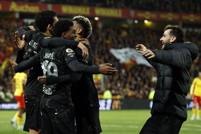 Paris Saint-Germain's French forward #49 Ibrahim Mbaye (2ndL) is congratulated by teammates after scoring a goal during the French L1 football match between RC Lens and Paris Saint-Germain (PSG) at the Stade Bollaert-Delelis stadium in Lens on May 13, 2026. (Photo by SIMON WOHLFAHRT / AFP)