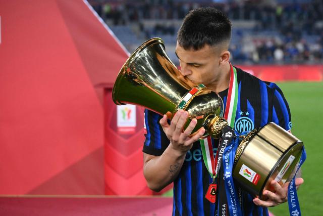 Inter Milan's Argentine forward #10 Lautaro Martinez kisses the trophy of the Italian Cup (Coppa Italia) after Inter won the final football match between Lazio Rome and Inter Milan at the Olympic stadium in Rome on May 13, 2026. (Photo by Alberto PIZZOLI / AFP)