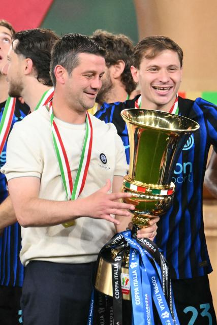 Inter Milan's Romanian head coach Cristian Chivu holds the trophy of the Italian Cup (Coppa Italia) after Inter won the final football match between Lazio Rome and Inter Milan at the Olympic stadium in Rome on May 13, 2026. (Photo by Alberto PIZZOLI / AFP)
