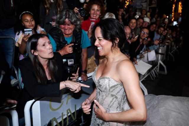 US actress Michelle Rodriguez reacts as he speaks with a fan upon arrival for the screening of the film "The Fast and the Furious" at the 79th edition of the Cannes Film Festival in Cannes, southern France on May 13, 2026. (Photo by Sameer AL-DOUMY / AFP)