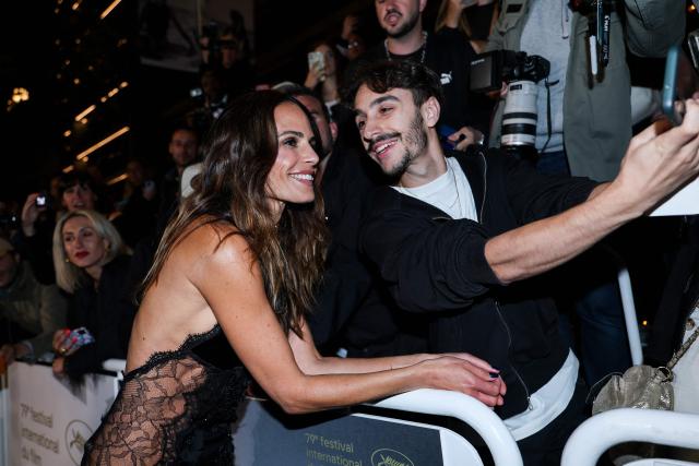 US actress Jordana Brewster poses for a selfie with a fan as she arrives for the screening of the film "The Fast and the Furious" at the 79th edition of the Cannes Film Festival in Cannes, southern France on May 13, 2026. (Photo by Sameer AL-DOUMY / AFP)