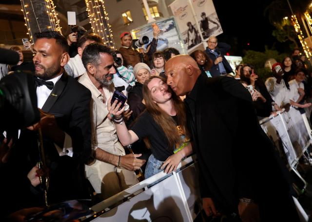 US actor Vin Diesel poses for a selfie with a fan as he arrives for the screening of the film "The Fast and the Furious" at the 79th edition of the Cannes Film Festival in Cannes, southern France on May 13, 2026. (Photo by Sameer AL-DOUMY / AFP)