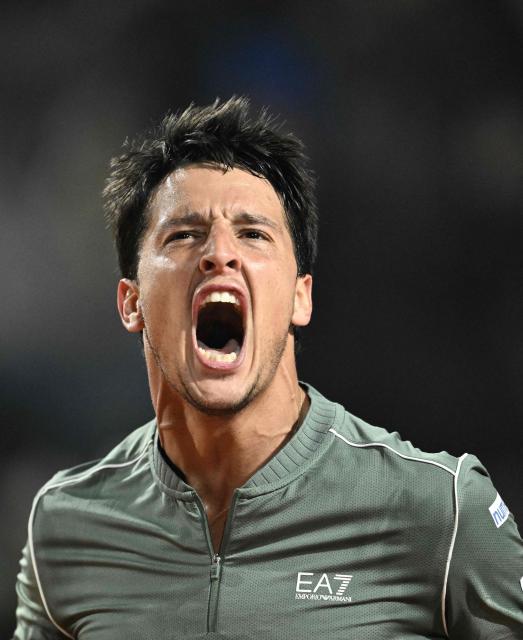 Italy's Luciano Darderi celebrates a point against Spain's Rafael Jodar during the ATP Rome Open tennis tournament at Foro Italico in Rome on May 13, 2026. (Photo by Tiziana FABI / AFP)