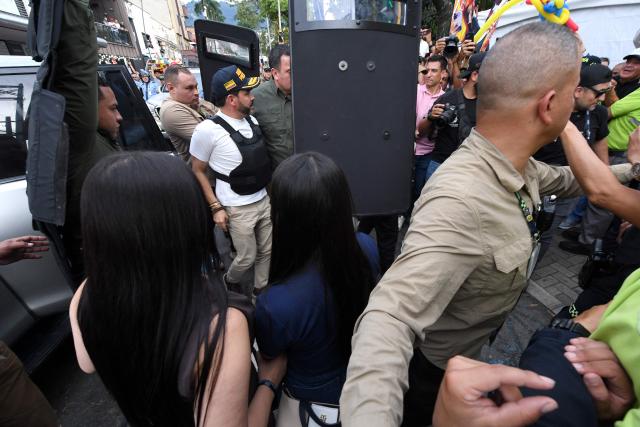 Colombia's right-wing presidential candidate Abelardo de la Espriella, from the Defensores de la Patria movement, is escorted by bodyguards with bulletproof shields as he arrives for a campaign rally in Envigado, Colombia on May 13, 2026. Colombia will hold presidential elections on May 31. (Photo by Jaime SALDARRIAGA / AFP)