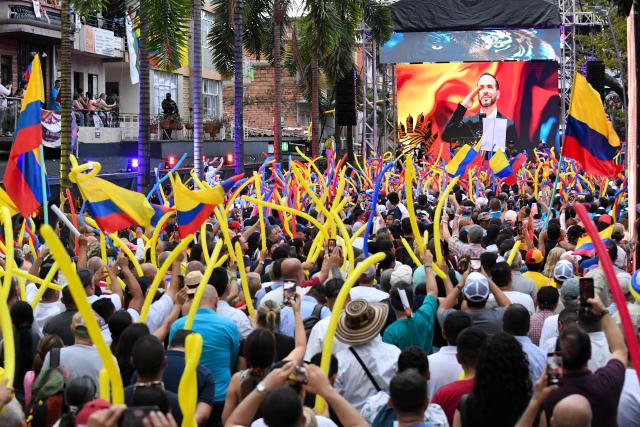 Supporters of Colombia's right-wing presidential candidate Abelardo de la Espriella, from the Defensores de la Patria movement, attend a campaign rally in Envigado, Colombia on May 13, 2026. Colombia will hold presidential elections on May 31. (Photo by Jaime SALDARRIAGA / AFP)