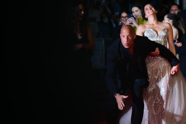 US actor Vin Diesel and US actress Michelle Rodriguez react as they arrive for the screening of the film "The Fast and the Furious" at the 79th edition of the Cannes Film Festival in Cannes, southern France on May 13, 2026. (Photo by Olivier CHASSIGNOLE / AFP)