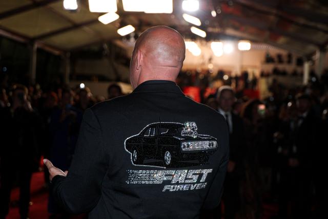 US actor Vin Diesel wears a jacket with a car figure embroidered on it as he arrives for the screening of the film "The Fast and the Furious" at the 79th edition of the Cannes Film Festival in Cannes, southern France on May 13, 2026. (Photo by Sameer AL-DOUMY / AFP)
