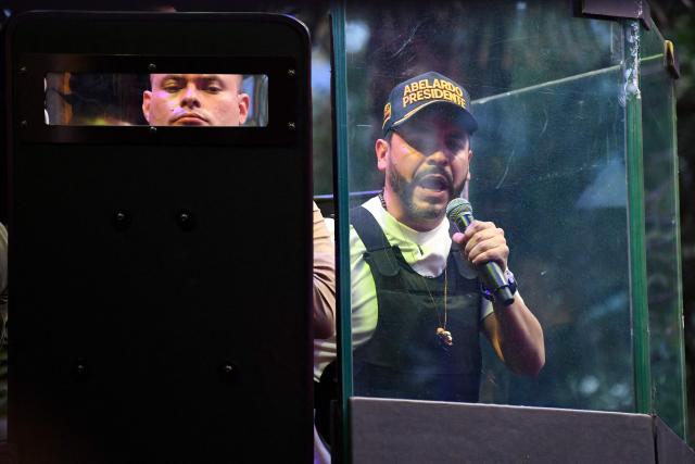 Colombia's right-wing presidential candidate Abelardo de la Espriella, from the Defensores de la Patria movement, speaks behind a bulletproof glass during a campaign rally in Envigado, Antioquia department, Colombia on May 13, 2026. Colombia will hold presidential elections on May 31. (Photo by Jaime SALDARRIAGA / AFP)