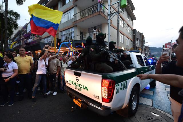 Colombian Police Special Operations Group officers patrol during a campaign rally of Colombia's right-wing presidential candidate Abelardo de la Espriella, from the Defensores de la Patria movement, in Envigado, Antioquia department, Colombia on May 13, 2026. Colombia will hold presidential elections on May 31. (Photo by Jaime SALDARRIAGA / AFP)