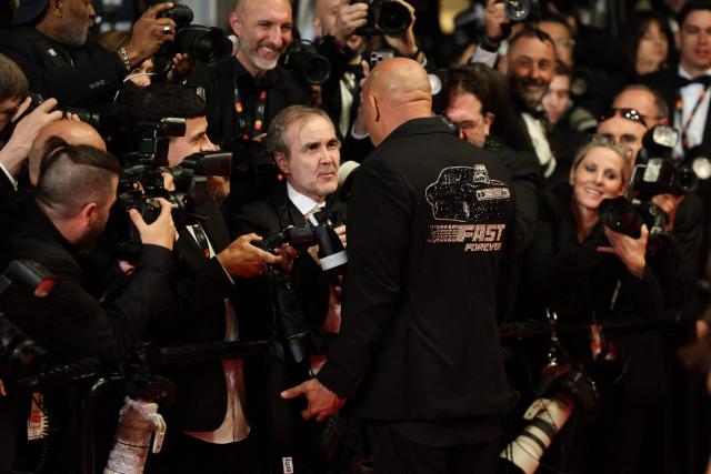 US actor Vin Diesel (R) interacts with photographers as he arrives for the screening of the film "The Fast and the Furious" at the 79th edition of the Cannes Film Festival in Cannes, southern France on May 13, 2026. (Photo by Thibaud MORITZ / AFP)