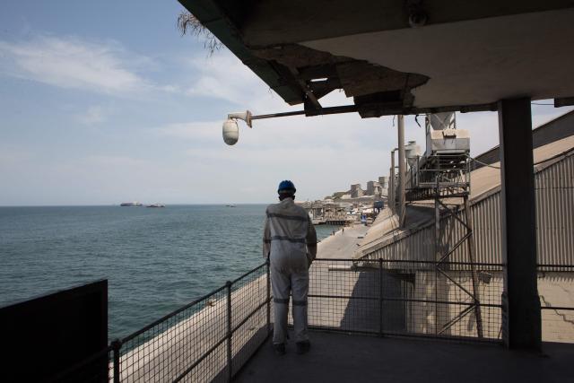 A worker stands at the Freetown Terminal in Freetown, on March 27, 2026. In many regions of West Africa, tapentadol is still sold as tramadol, with even authorities using tramadol as a generic umbrella code for all pharmaceutical opioids. Tapentadol pills and capsules, a powerful synthetic opioid that Indian pharmaceutical companies have been exporting to the region in strengths not approved in India, not registered in the destination countries, and not authorised by any recognised international regulatory body. (Photo by Saidu BAH / AFP)