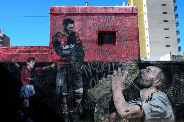 Images of Argentine footballer Lionel Messi, including depictions of his youth and World Cup victory, are painted on a mural in Rosario, Santa Fe province, Argentina, on April 30, 2026. At the age of 12, Lionel Messi ended the career of his first coach. When Enrique Dominguez stopped coaching him in 1999 at the youth club Malvinas Argentinas in the city of Rosario, he resigned, saying he had "already coached the best player in the world", who could now be set to play in his sixth World Cup. (Photo by Marcelo Manera / AFP)