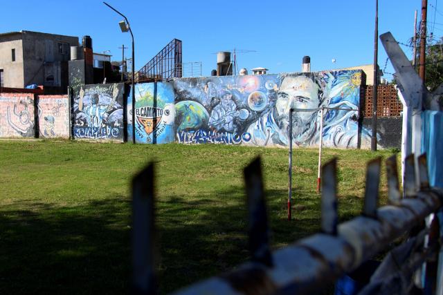 A mural of Argentine footballer Lionel Messi is seen at a football pitch known as "El Campito", where he played as a child, in his childhood neighborhood in Rosario, Santa Fe province, Argentina, on April 30, 2026. At the age of 12, Lionel Messi ended the career of his first coach. When Enrique Dominguez stopped coaching him in 1999 at the youth club Malvinas Argentinas in the city of Rosario, he resigned, saying he had "already coached the best player in the world", who could now be set to play in his sixth World Cup. (Photo by Marcelo Manera / AFP)