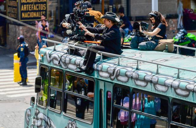 U2 singer Paul Hewson (C), known as Bono, gestures during the second day of recording of its music video in downtown Mexico City on May 13, 2026. (Photo by Alfredo ESTRELLA / AFP)