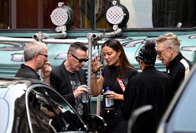 U2 drummer Larry Mullen Jr. (2nd L) and bassist Adam Clayton (R) are seen during the second day of recording of its music video in downtown Mexico City on May 13, 2026. (Photo by Alfredo ESTRELLA / AFP)