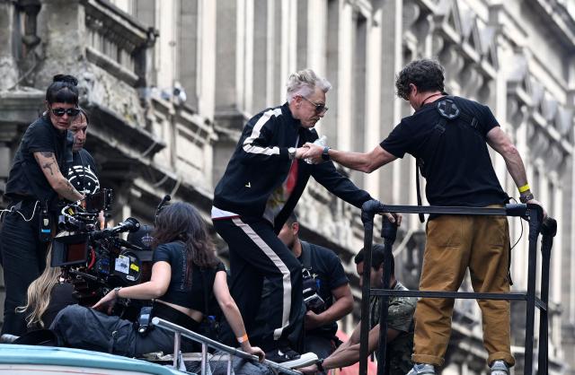 U2 bassist Adam Clayton (C) is seen during the second day of recording of its music video in downtown Mexico City on May 13, 2026. (Photo by Alfredo ESTRELLA / AFP)