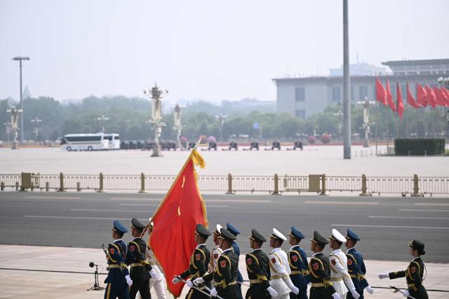 Chinese honour guard take their position at the Great Hall of the People ahead of a welcome ceremony for US President Donald Trump in Beijing on May 14, 2026. (Photo by Brendan SMIALOWSKI / AFP)