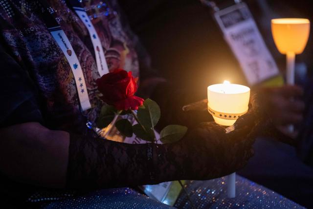 Attendees hold candles during the 38th National Law Enforcement Officers Memorial Fund candlelight vigil commemorating fallen officers at the National Mall in Washington, DC, on May 13, 2026. (Photo by SAUL LOEB / AFP)