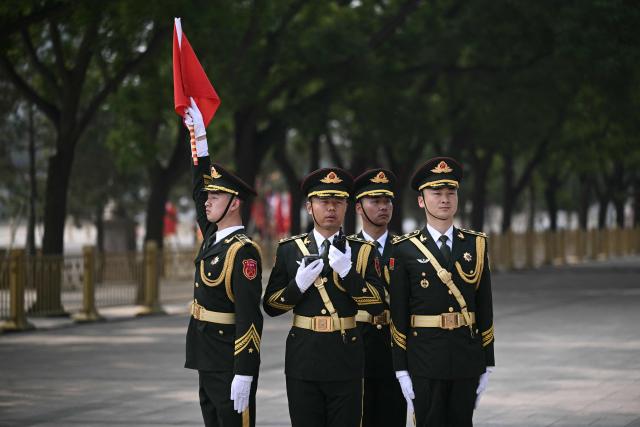 Chinese honour guard take their position at the Great Hall of the People ahead of a welcome ceremony for US President Donald Trump in Beijing on May 14, 2026. (Photo by Brendan SMIALOWSKI / AFP)