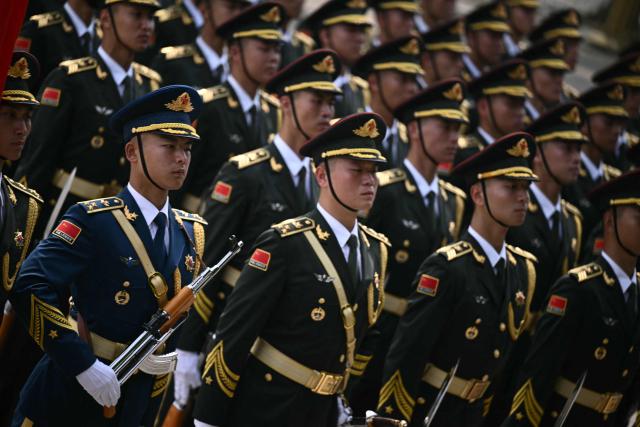 Chinese honour guard take their position at the Great Hall of the People ahead of a welcome ceremony for US President Donald Trump in Beijing on May 14, 2026. (Photo by Brendan SMIALOWSKI / AFP)
