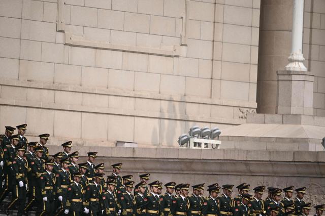 Chinese honour guard take their position at the Great Hall of the People ahead of a welcome ceremony for US President Donald Trump in Beijing on May 14, 2026. (Photo by Brendan SMIALOWSKI / AFP)