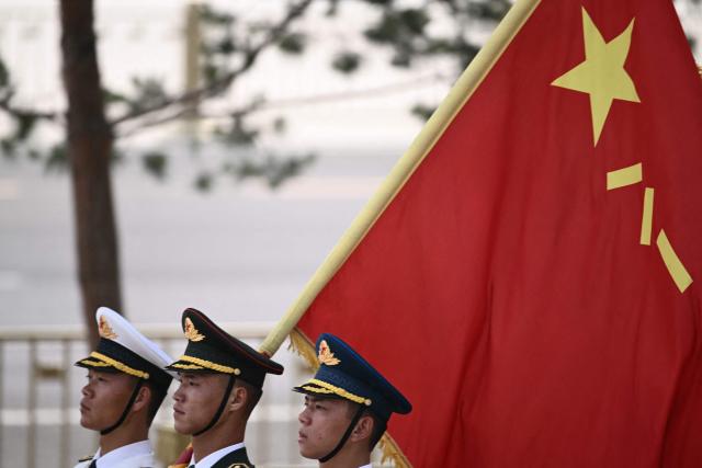 Chinese honour guard take their position at the Great Hall of the People ahead of a welcome ceremony for US President Donald Trump in Beijing on May 14, 2026. (Photo by Brendan SMIALOWSKI / AFP)