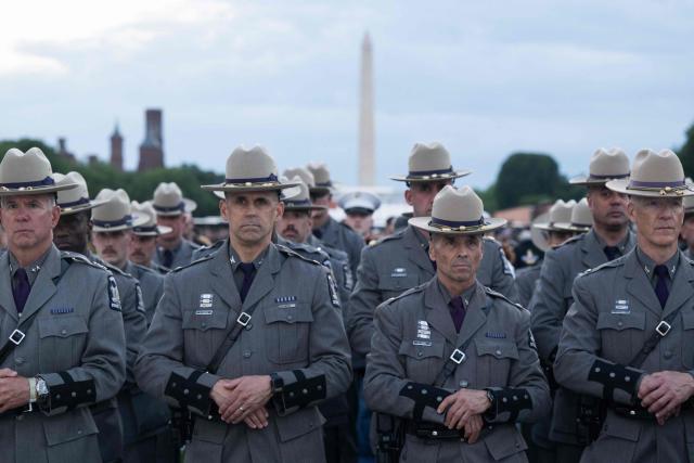 Members of the New York State Police Department attend the 38th National Law Enforcement Officers Memorial Fund candlelight vigil commemorating fallen officers at the National Mall in Washington, DC, on May 13, 2026. (Photo by SAUL LOEB / AFP)