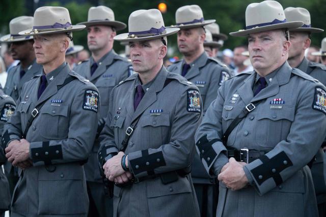 Members of the New York State Police Department attend the 38th National Law Enforcement Officers Memorial Fund candlelight vigil commemorating fallen officers at the National Mall in Washington, DC, on May 13, 2026. (Photo by SAUL LOEB / AFP)