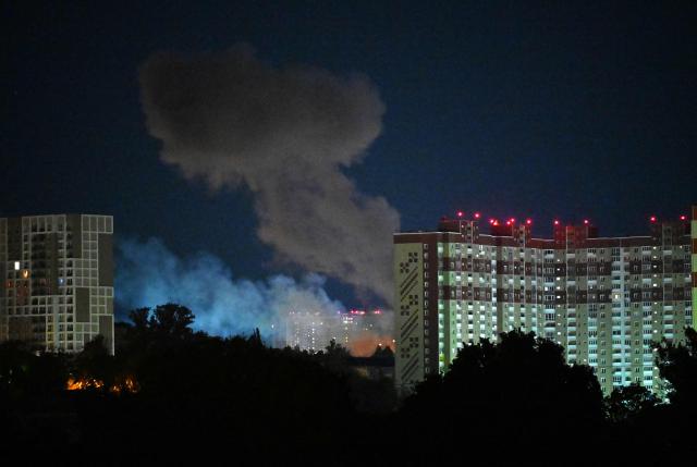 Smoke rises from an explosion among multi-storey residential buildings during Russian drones and missiles strikes in Kyiv on May 14, 2026, amid the Russian invasion in Ukraine. Ukraine's capital came under heavy aerial attack early on May 14, an AFP journalist reported, as Kyiv's mayor said Russia was striking the city. (Photo by Sergei SUPINSKY / AFP)