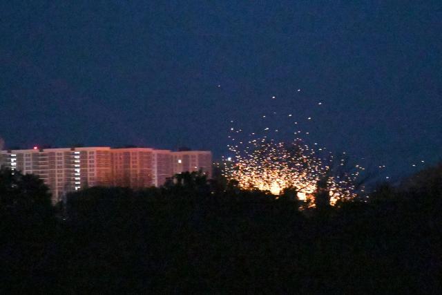 This photograph shows an explosion near multi-storey residential buildings during Russian drones and missiles strikes in Kyiv on May 14, 2026, amid the Russian invasion in Ukraine. Ukraine's capital came under heavy aerial attack early on May 14, an AFP journalist reported, as Kyiv's mayor said Russia was striking the city. (Photo by Sergei SUPINSKY / AFP)