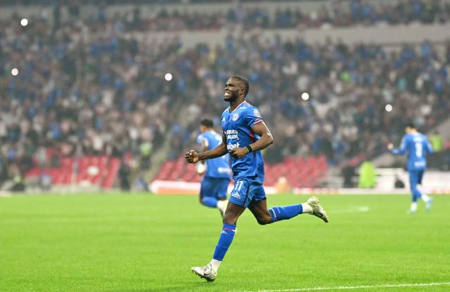 Cruz Azul's Nigerian forward #11 Christian Ebere celebrates after scoring the equalising goal from the penalty spot during the Liga MX Clausura semifinal first-leg football match between Cruz Azul and Guadalajara at Banorte Stadium in Mexico City on May 13, 2026. (Photo by CARL DE SOUZA / AFP)