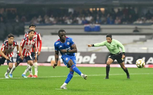 Cruz Azul's Nigerian forward #11 Christian Ebere scores the equalising goal from the penalty spot during the Liga MX Clausura semifinal first-leg football match between Cruz Azul and Guadalajara at Banorte Stadium in Mexico City on May 13, 2026. (Photo by CARL DE SOUZA / AFP)