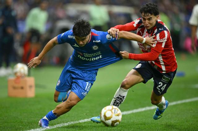 Cruz Azul's forward #18 Luka Romero AND Guadalajara's defender #24 Miguel Gomez fight for the ball during the Liga MX Clausura semifinal first-leg football match between Cruz Azul and Guadalajara at Banorte Stadium in Mexico City on May 13, 2026. (Photo by CARL DE SOUZA / AFP)