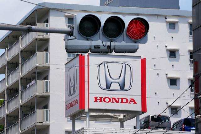 The logo of Japanese automaker Honda is pictured on a billboard at a Honda dealership in Tokyo on May 14, 2026. (Photo by Kazuhiro NOGI / AFP)