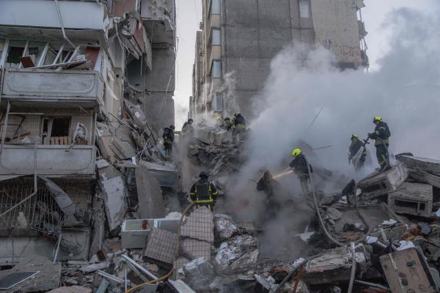 Rescuers work at a residential building partially destroyed following Russian drones and missiles strikes in Kyiv on May 14, 2026, amid the Russian invasion in Ukraine. Ukraine's capital came under heavy aerial attack early on May 14, an AFP journalist reported, as Kyiv's mayor said Russia was striking the city. (Photo by Roman PILIPEY / AFP)