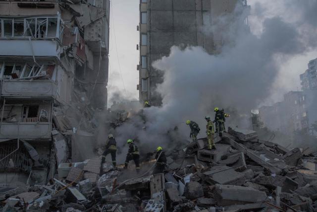 Rescuers work at a residential building partially destroyed following Russian drones and missiles strikes in Kyiv on May 14, 2026, amid the Russian invasion in Ukraine. Ukraine's capital came under heavy aerial attack early on May 14, an AFP journalist reported, as Kyiv's mayor said Russia was striking the city. (Photo by Roman PILIPEY / AFP)