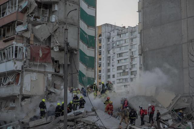 Rescuers work at a residential building partially destroyed following Russian drones and missiles strikes in Kyiv on May 14, 2026, amid the Russian invasion in Ukraine. Ukraine's capital came under heavy aerial attack early on May 14, an AFP journalist reported, as Kyiv's mayor said Russia was striking the city. (Photo by Roman PILIPEY / AFP)