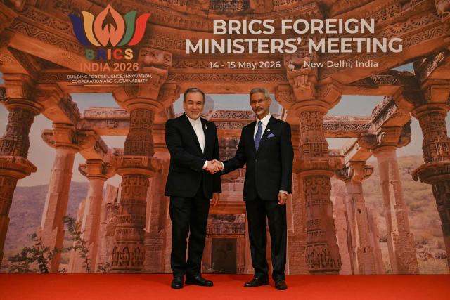 India's Foreign Minister Subrahmanyam Jaishankar (R) welcomes his Iran's counterpart Abbas Araghchi for the opening of the BRICS Foreign Ministers’ Meeting at the Bharat Mandapam in New Delhi on May 14, 2026. (Photo by Arun SANKAR / AFP)