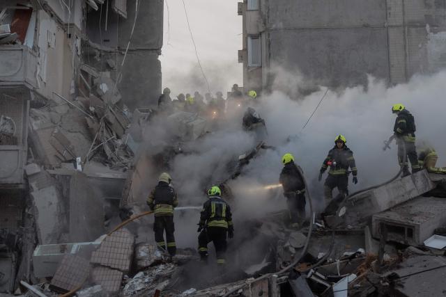 Rescuers work at a residential building partially destroyed following Russian drone and missile strikes in Kyiv on May 14, 2026, amid the Russian invasion in Ukraine. Ukraine's capital came under heavy aerial attack early on May 14, an AFP journalist reported, as Kyiv's mayor said Russia was striking the city. (Photo by Roman PILIPEY / AFP)