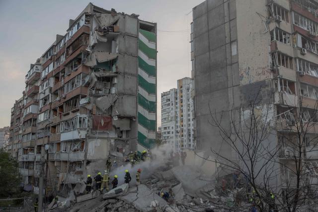 Rescuers work at a residential building partially destroyed following Russian drone and missile strikes in Kyiv on May 14, 2026, amid the Russian invasion in Ukraine. Ukraine's capital came under heavy aerial attack early on May 14, an AFP journalist reported, as Kyiv's mayor said Russia was striking the city. (Photo by Roman PILIPEY / AFP)