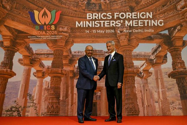 India's Foreign Minister Subrahmanyam Jaishankar (R) welcomes the United Arab Emirates' Minister of State for Foreign Affairs and International Cooperation Khalifa Shaheen Almarar for the opening of the BRICS Foreign Ministers’ Meeting at the Bharat Mandapam in New Delhi on May 14, 2026. (Photo by Arun SANKAR / AFP)