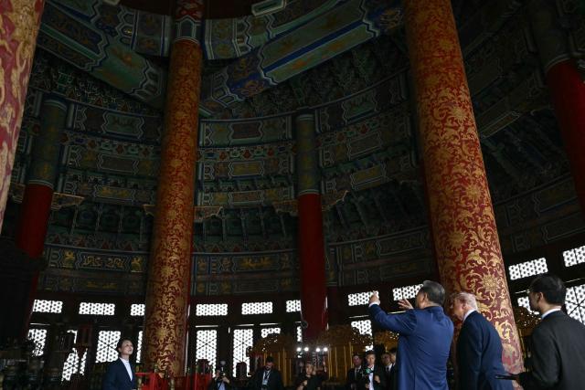 China's President Xi Jinping (3rd R) and US President Donald Trump (2nd R) visit the Temple of Heaven in Beijing on May 14, 2026. Xi warned Trump that the issue of Taiwan could push their two countries into "conflict" if mishandled, a stark opening salvo as a superpower summit set to tackle numerous thorny issues began in Beijing on May 14. (Photo by Brendan SMIALOWSKI / POOL / AFP)
