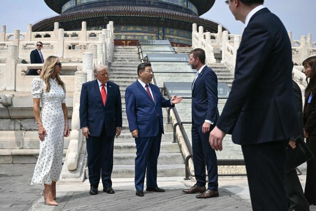 China's President Xi Jinping (2nd R) speaks with Eric Trump (R) as US President Donald Trump (2nd L) and Lara Trump look on at the Temple of Heaven in Beijing on May 14, 2026. Xi warned Trump that the issue of Taiwan could push their two countries into "conflict" if mishandled, a stark opening salvo as a superpower summit set to tackle numerous thorny issues began in Beijing on May 14. (Photo by Brendan SMIALOWSKI / POOL / AFP)