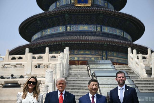 China's President Xi Jinping (2nd R) and US President Donald Trump (2nd L) pose for a photo with Eric Trump (R) and his spouse Lara Trump at the Temple of Heaven in Beijing on May 14, 2026. Xi warned Trump that the issue of Taiwan could push their two countries into "conflict" if mishandled, a stark opening salvo as a superpower summit set to tackle numerous thorny issues began in Beijing on May 14. (Photo by Brendan SMIALOWSKI / POOL / AFP)