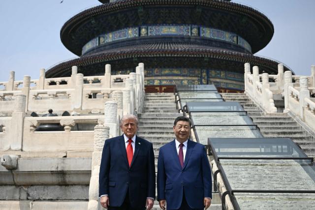 China's President Xi Jinping (R) and US President Donald Trump pose for a photo at the Temple of Heaven in Beijing on May 14, 2026. Xi warned Trump that the issue of Taiwan could push their two countries into "conflict" if mishandled, a stark opening salvo as a superpower summit set to tackle numerous thorny issues began in Beijing on May 14. (Photo by Brendan SMIALOWSKI / POOL / AFP)