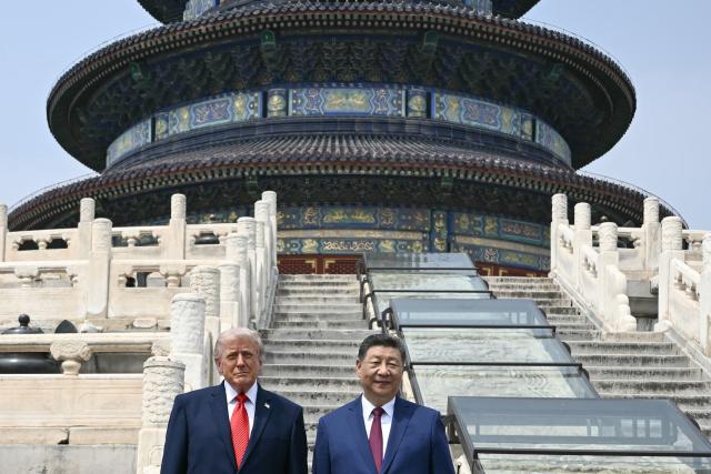 China's President Xi Jinping (R) and US President Donald Trump pose for a photo at the Temple of Heaven in Beijing on May 14, 2026. Xi warned Trump that the issue of Taiwan could push their two countries into "conflict" if mishandled, a stark opening salvo as a superpower summit set to tackle numerous thorny issues began in Beijing on May 14. (Photo by Brendan SMIALOWSKI / POOL / AFP)