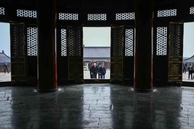 China's President Xi Jinping (R) and US President Donald Trump visit the Temple of Heaven in Beijing on May 14, 2026. Xi warned Trump that the issue of Taiwan could push their two countries into "conflict" if mishandled, a stark opening salvo as a superpower summit set to tackle numerous thorny issues began in Beijing on May 14. (Photo by Brendan SMIALOWSKI / POOL / AFP)